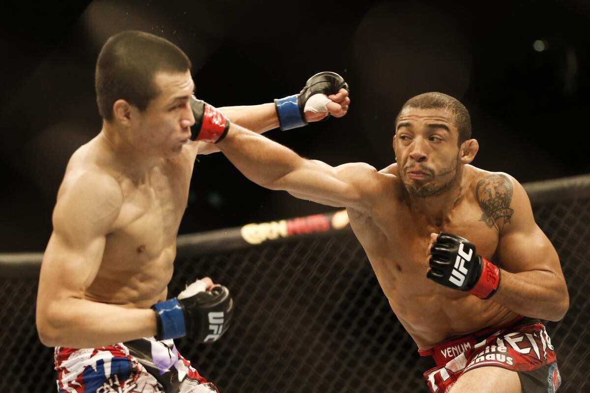 Jose Aldo, right, delivers a punch to the head of Chan Sung Jung during their featherweight bout at UFC 163 in 2013. Aldo won the fight.