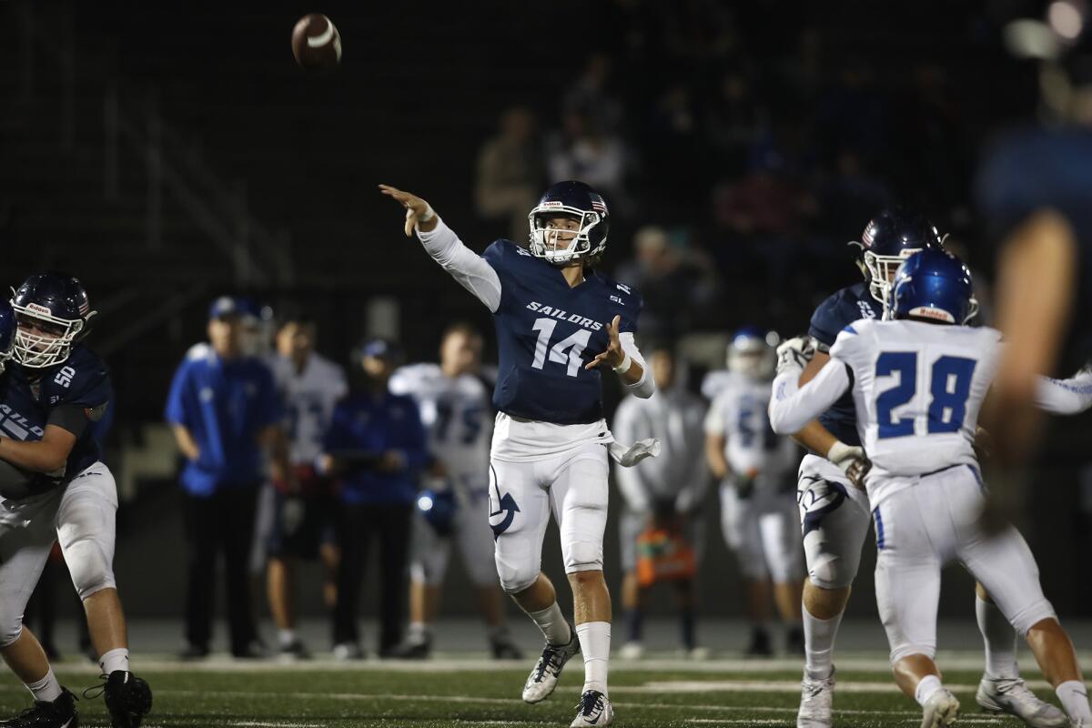 Newport Harbor quarterback Cole Lavin (14) throws a 15-yard touchdown to receiver Jake Keliikoa in the second quarter against San Marino on Friday.