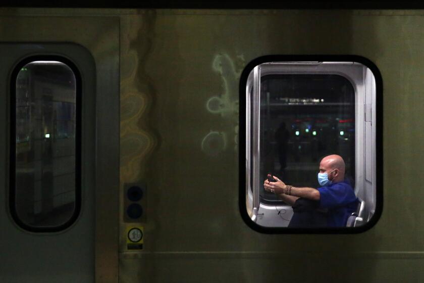 LOS ANGELES, CA - JULY 20: A person rides the blue line towards Santa Monica on Monday, July 20, 2020 in Los Angeles, CA. Officials reported 2,848 newly confirmed COVID-19 cases on Sunday as hospitalizations have reached a new high. (Dania Maxwell / Los Angeles Times)