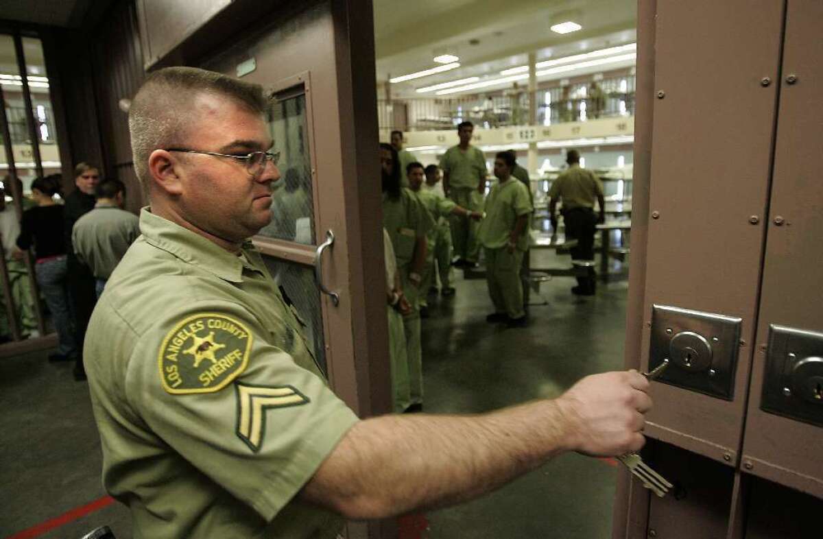 A sheriff's deputy locks down inmates in a cellblock at the North County Correctional Facility at the Pitchess Dentention Center in Castaic in 2006.