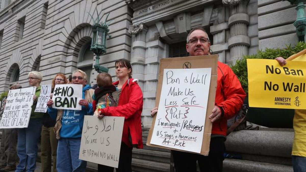 Protesters against President Trump's ban on entry for refugees and other immigrants from seven mostly Muslim nations stand outside a federal appeals court in San Francisco on Tuesday.