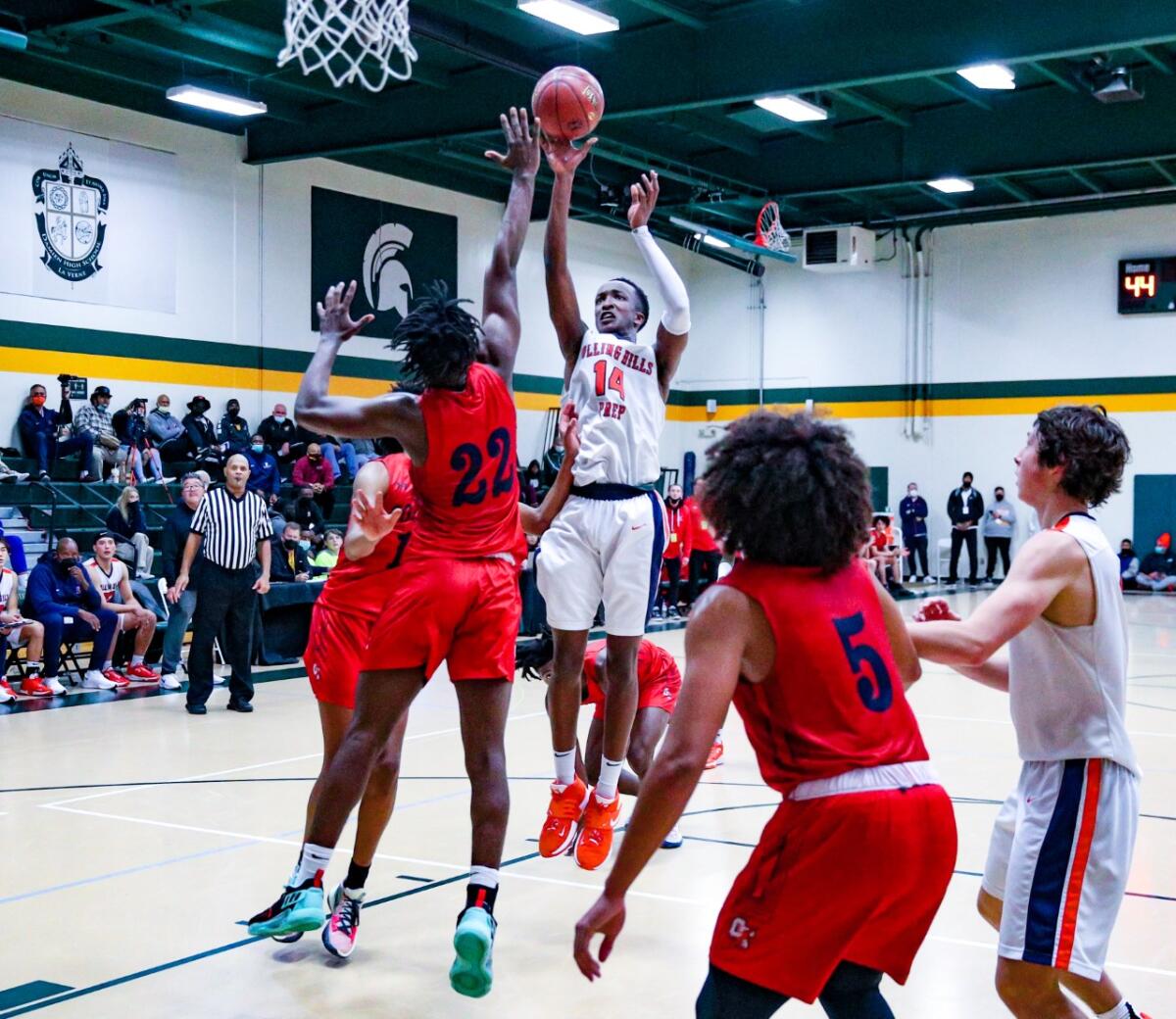 Kenny Manzi of Rolling Hills Prep tries to score over Denzel Hinds of Colony at Damien. Rolling Hills Prep won 50-43.