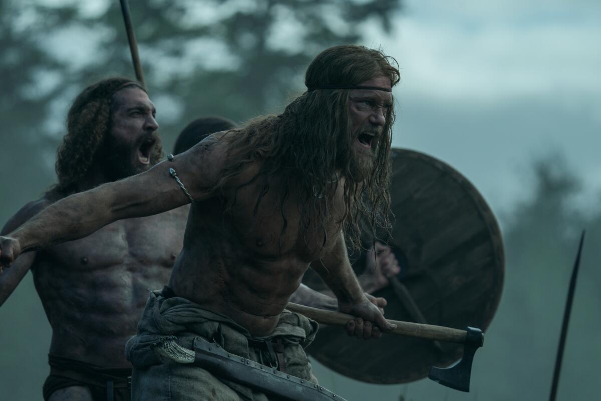 Two bare-chested, unkempt men with long hair bellow while holding swords and shields.