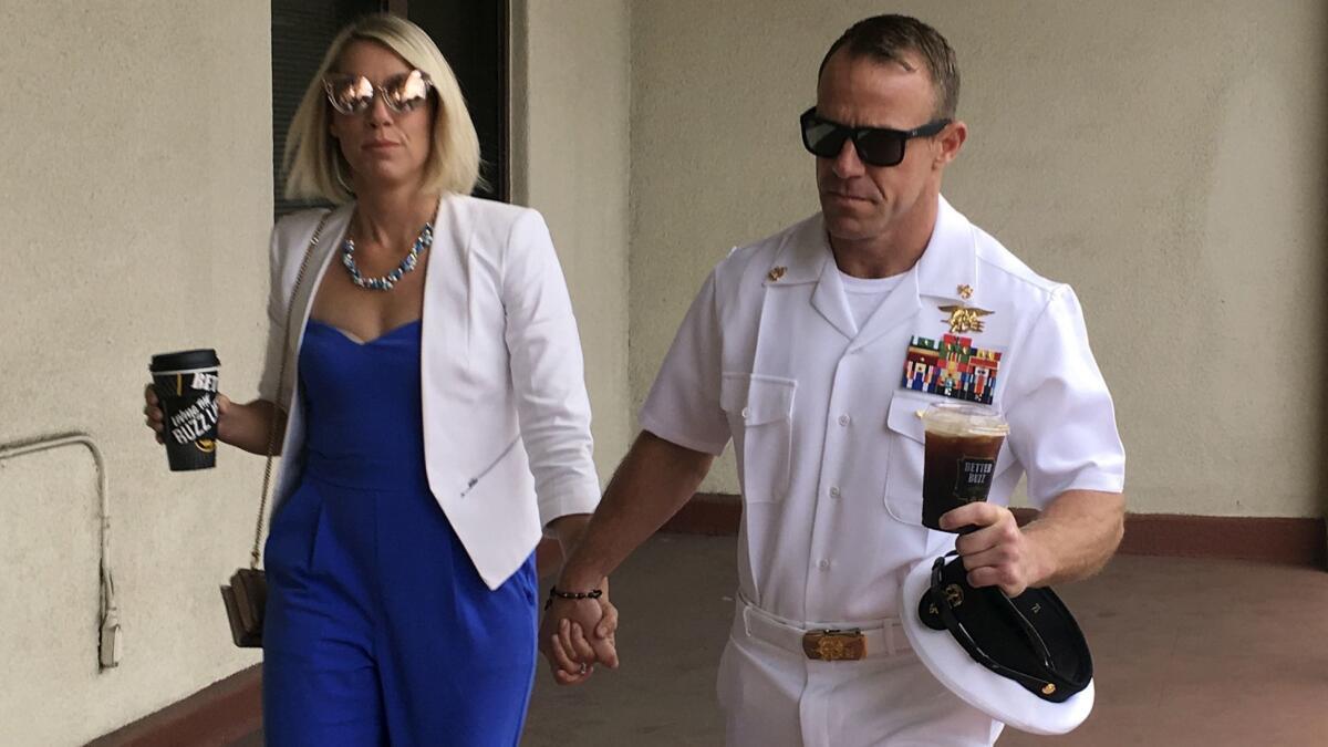 Navy Special Operations Chief Edward Gallagher, right, walks with his wife, Andrea Gallagher, as they arrive at military court in San Diego on Wednesday.
