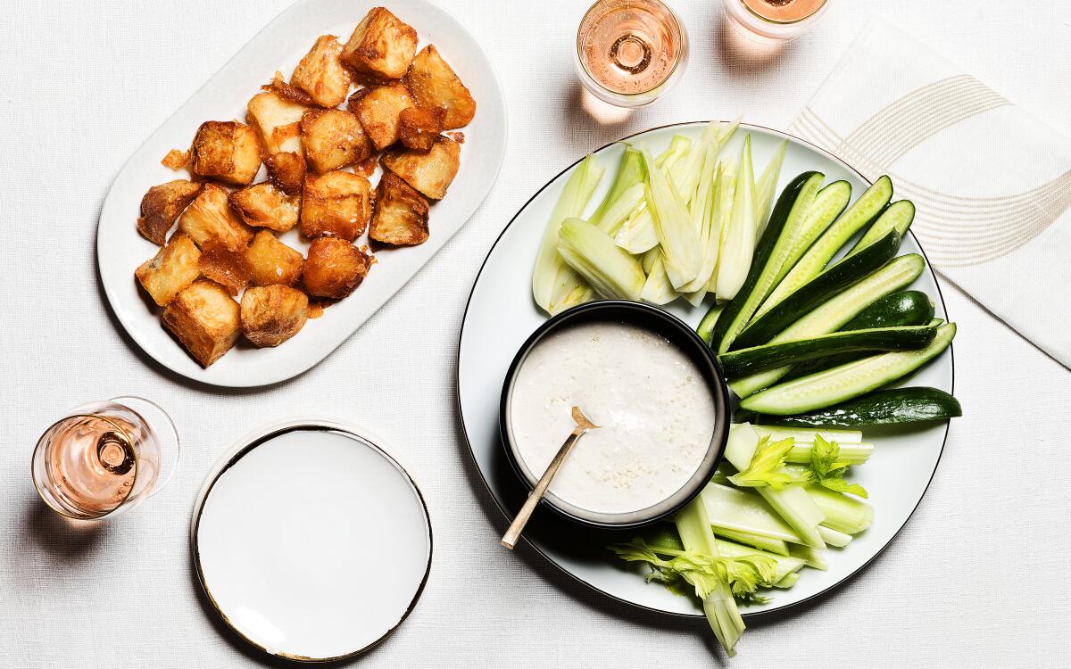 Hot fried potatoes and cold crudité make the perfect pairing for a holiday appetizer when served with a Caesar dip.