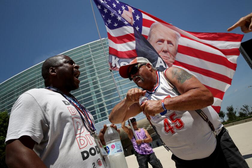 TULSA, OKLAHOMA - JUNE 18: Nicholas Winford (L) debates Trump supporter Randall Thom (R), on the racial policies of U.S. President Donald Trump outside the BOK Center June 18, 2020 in Tulsa, Oklahoma. Trump is scheduled to hold his first political rally since the start of the coronavirus pandemic at the BOK Center on Saturday while infection rates in the state of Oklahoma continue to rise. (Photo by Win McNamee/Getty Images)