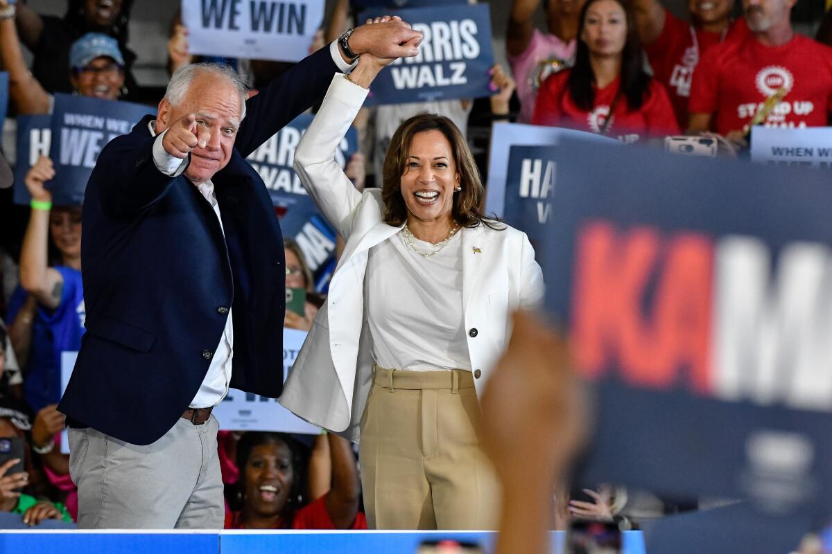 Tim Walz and Kamala Harris with an enthusiastic crowd