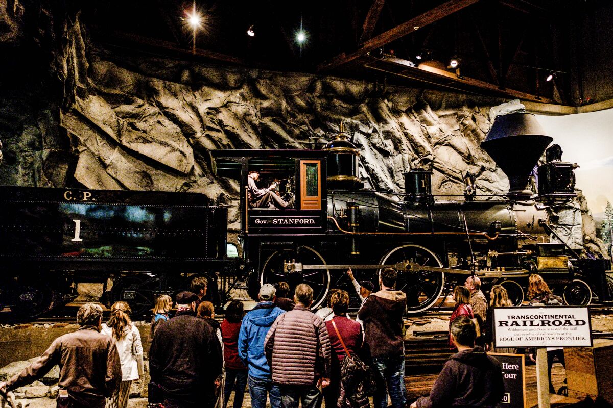 People in front of a train car at the California State Railroad Museum