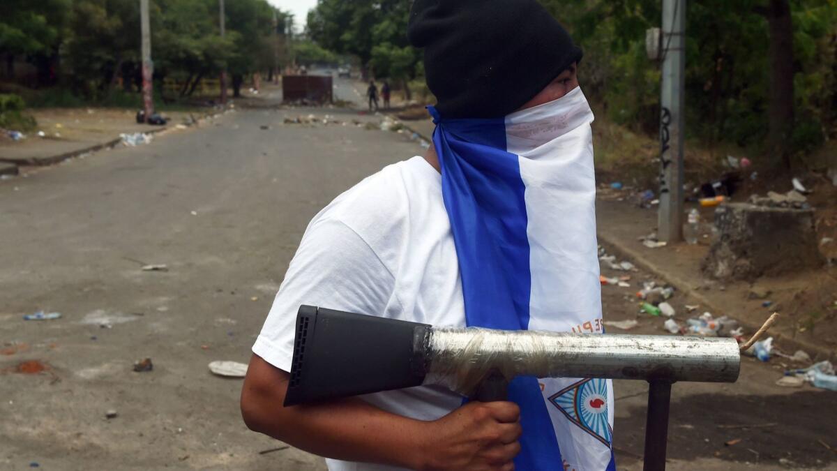 A student holds a handmade mortar during protests in the Nicaraguan capital of Managua.