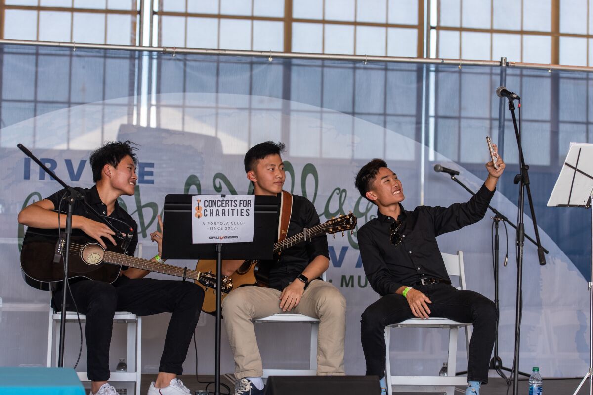 Tom Doan, John Zhu, Gabriel Chen take a selfie before performing at the Irvine Global Village Festival.