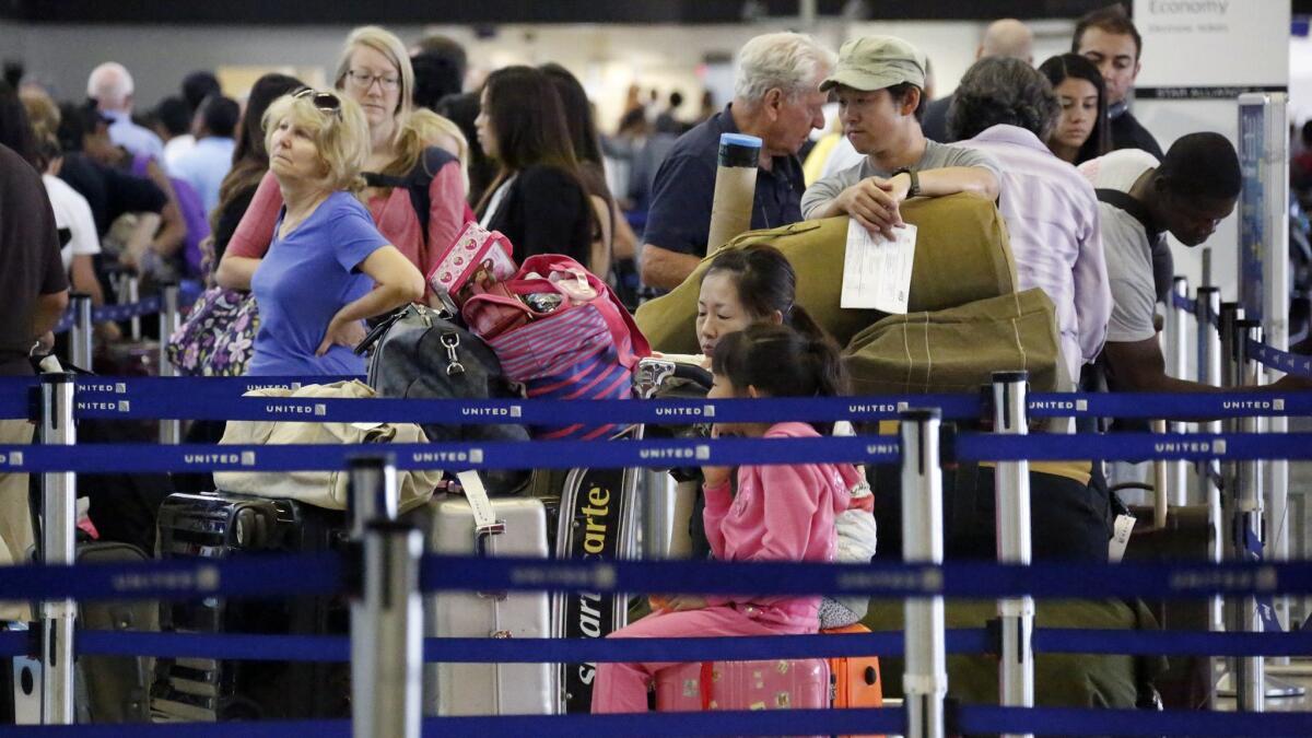 Passengers wait to check in for Labor Day weekend travel on Aug. 30, 2013, at Los Angeles International Airport. LAX is expected to see a record number of travelers for the 2018 Labor Day weekend.