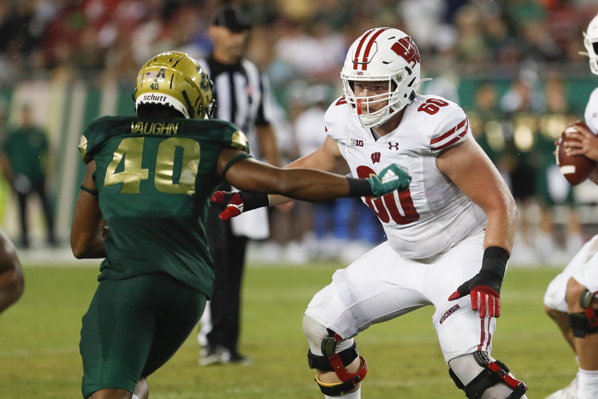 Wisconsin Badgers offensive lineman Logan Bruss (60) blocks South Florida Bulls defensive end Jason Vaughn.