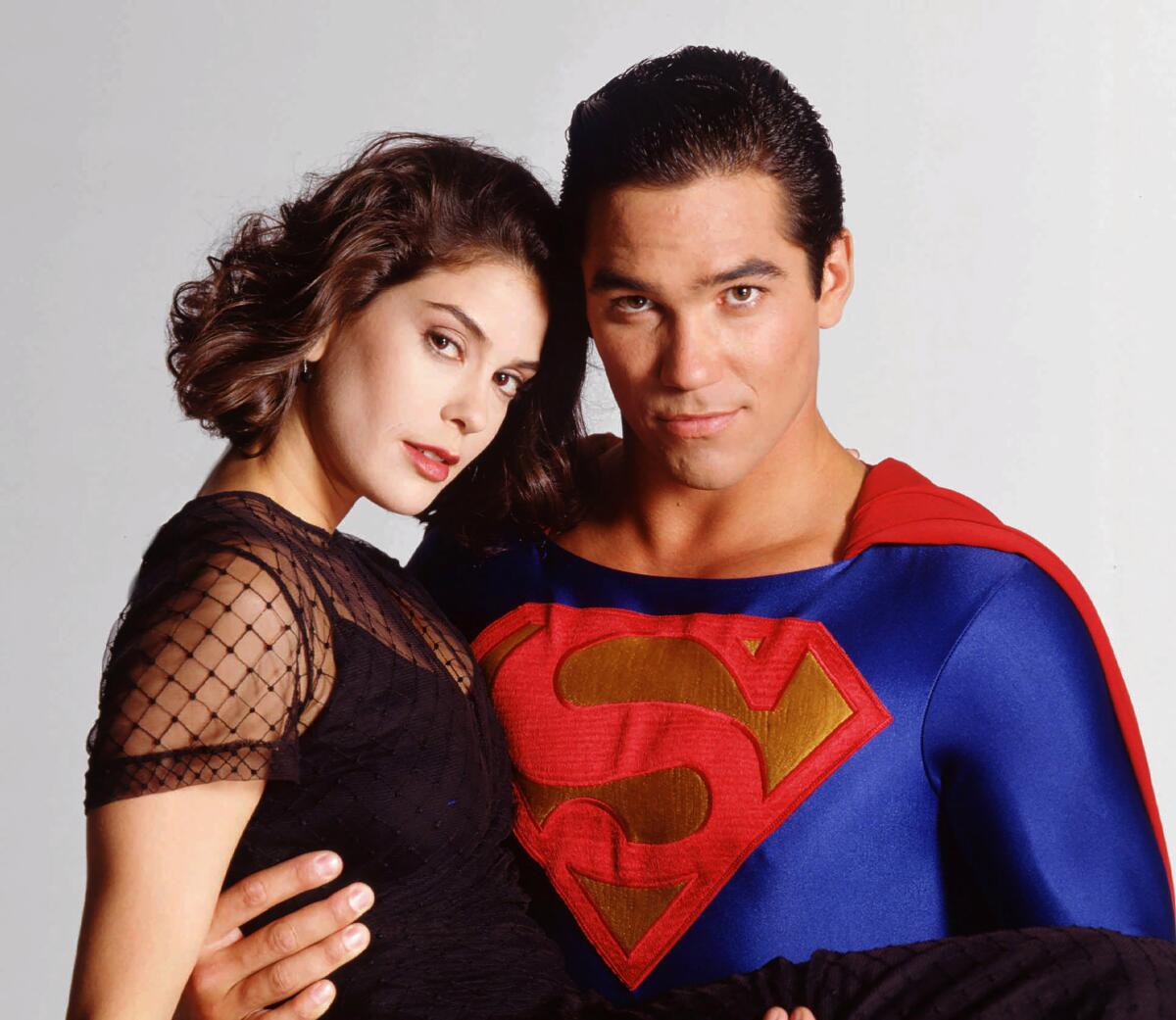 Teri Hatcher, left, as Lois Lane in a black sheer dress is held by Dean Cain, who is in a Superman uniform.