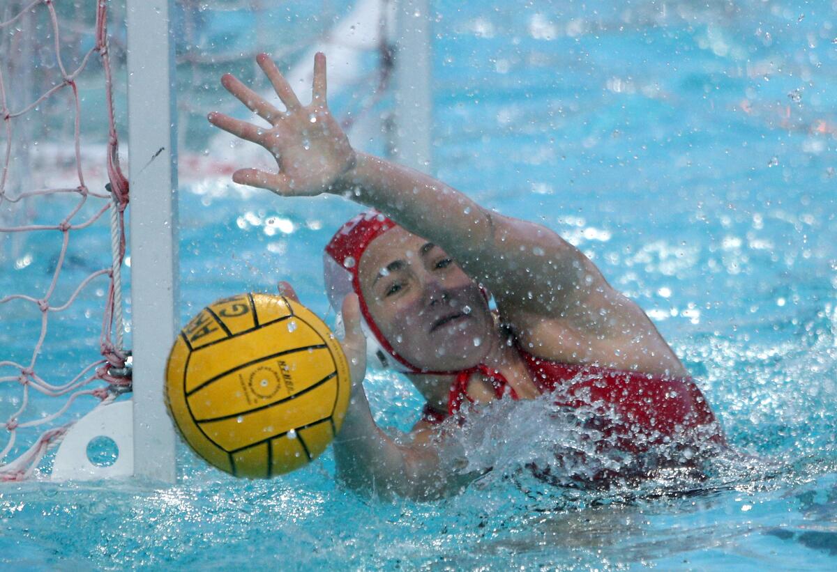 Burroughs High goalkeeper Ema Nathan makes a save in the Pacific League Tournament semifinal match against Crescenta Valley.