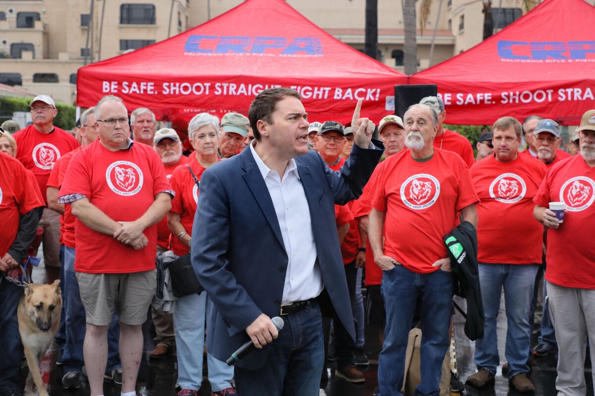 Carl DeMaio speaks at an early morning rally in September for the California Rifle & Pistol Assn. outside the entrance to the Crossroads of the West Gun Show at the Del Mar Fairgrounds.