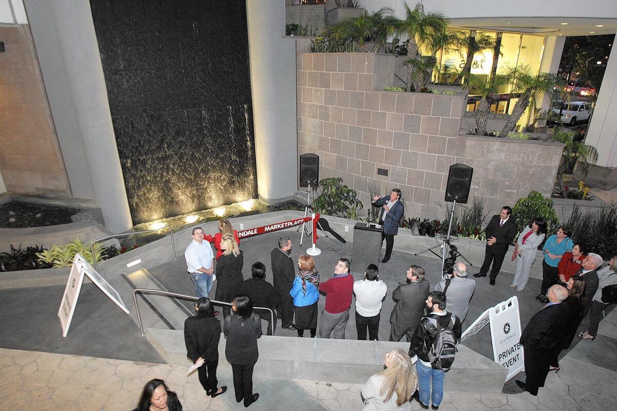 A face-lift is dedicated at the Glendale Marketplace on Wednesday. The water wall at the entrance replaced the frog fountain that had been in place for several years.
