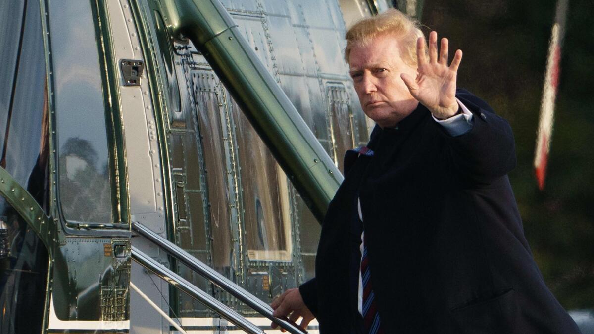 President Trump boards Marine One on Friday after leaving Walter Reed National Military Medical Center in Bethesda, Md.