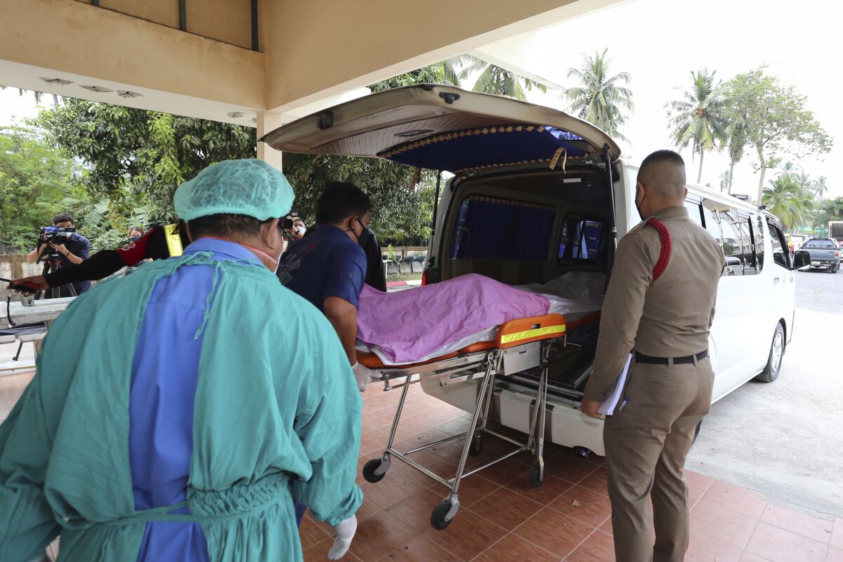 Staff members help move the body of Shane Warne from Ko Samui Hospital on Ko Samui island, southern Thailand, Sunday, March 6, 2022, to a ferry on the way to Surat Thani province's main hospital for an autopsy. Warne, whose artful and record-breaking spin bowling on the cricket field was matched by his impish allure and often controversial career off the pitch, was remembered by all manner of athletes, actors, prime ministers and rock stars on Saturday following his death from an apparent heart attack. He was 52. (AP Photo/Thanapat Cherajin)