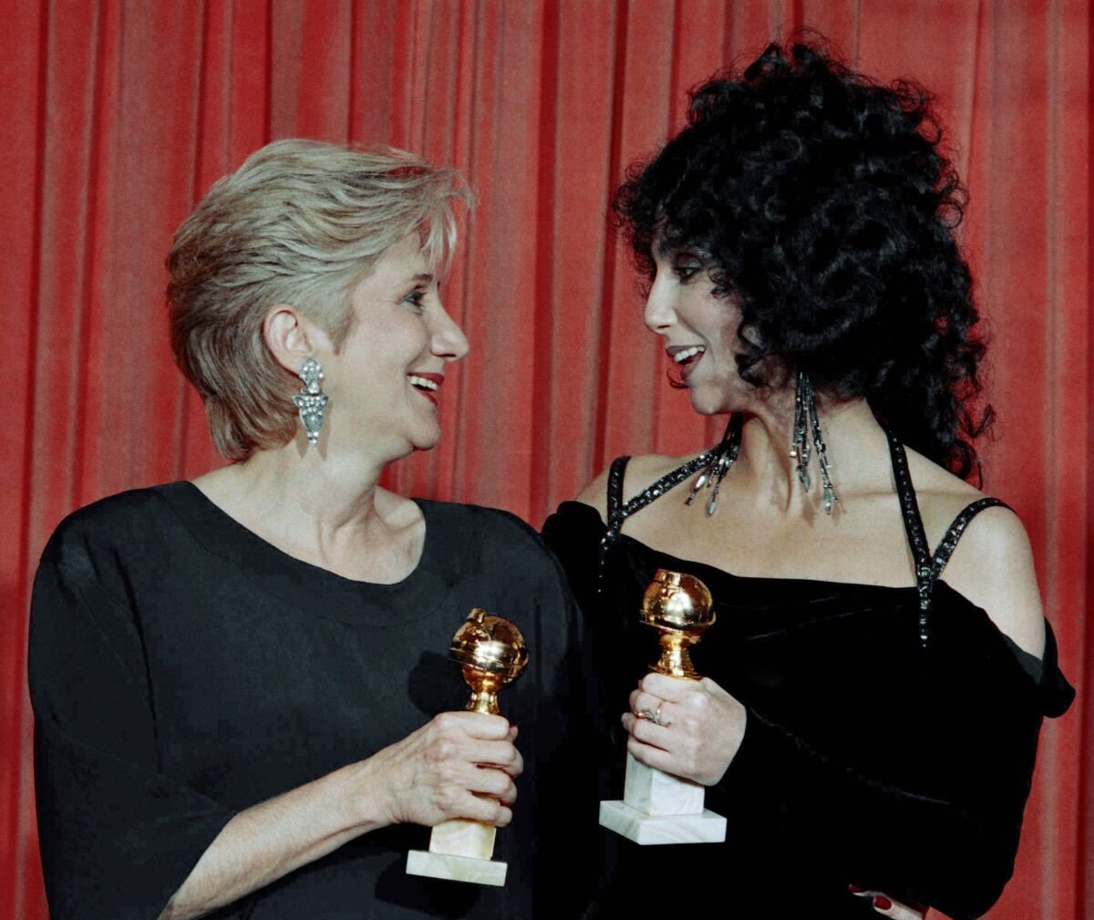 FILE - In this Jan. 24, 1988 file photo, Actress Olympia Dukakis, winner of a Golden Globe for "Best Performance in a Supporting Role" and Cher, winner of the "Best Performance by an Actress in a musical or comedy", hold the awards they received for performances in the hit movie "Moonstruck" at the Beverly Hilton Hotel. Olympia Dukakis, the veteran stage and screen actress whose flair for maternal roles helped her win an Oscar as Cher’s mother in the romantic comedy “Moonstruck,” has died. She was 89. (AP Photo/Reed Saxon, File)