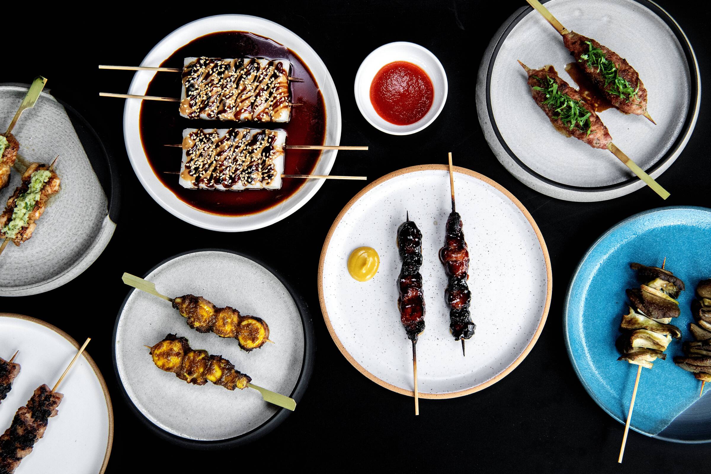 An array of skewers on plates