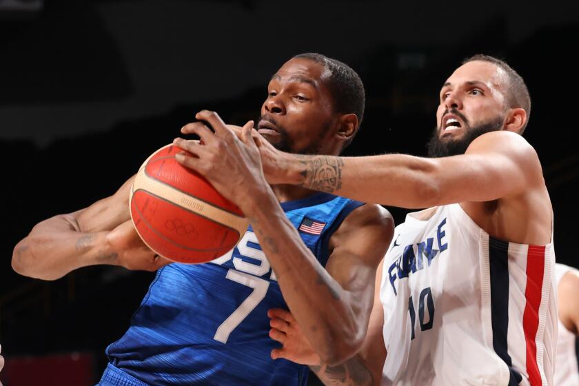 Team France shooting guard Evan Fournier (10) knocks the ball from Team United States forward.
