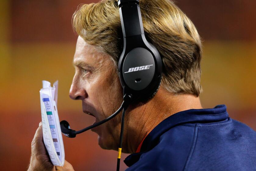 Broncos defensive coordinator Jack Del Rio talks to an assistant on his headset during a game against the Indianapolis Colts earlier this season in Denver.