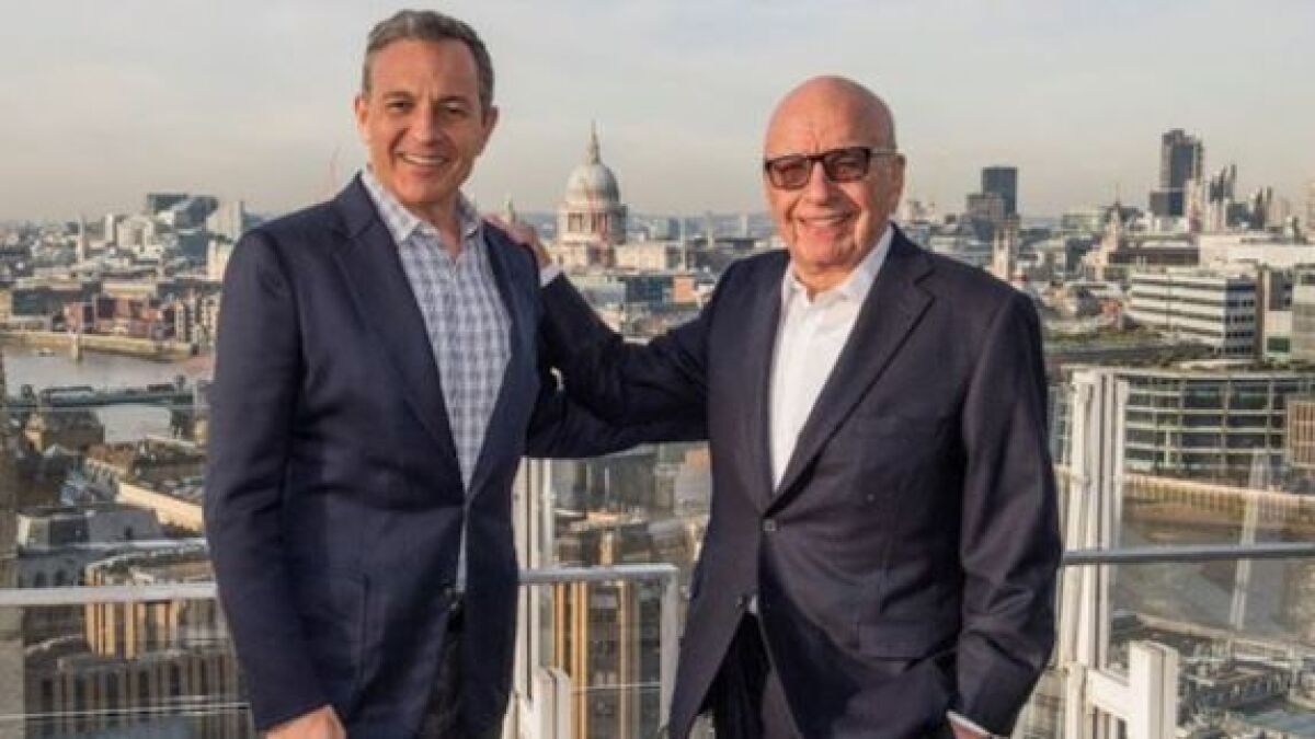 Bob Iger, left, chief executive of Walt Disney Co., and Fox Chairman Rupert Murdoch celebrate in London in December after announcing Disney's $52.4-billion proposal to acquire much of Fox.