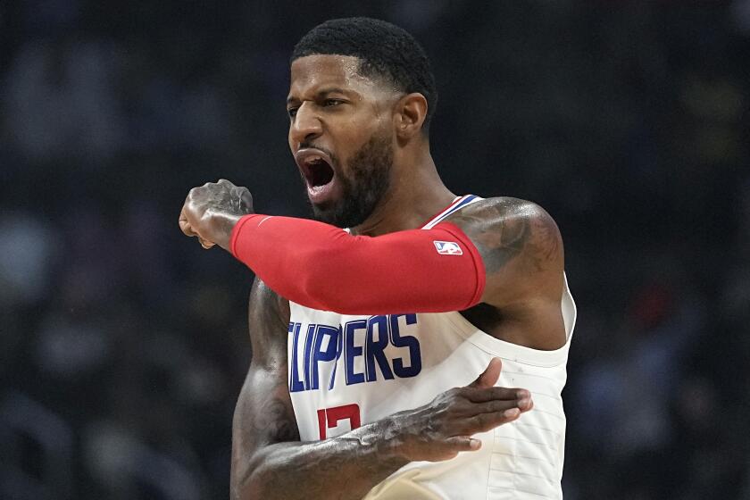 Los Angeles Clippers guard Paul George celebrates after scoring during the first half.
