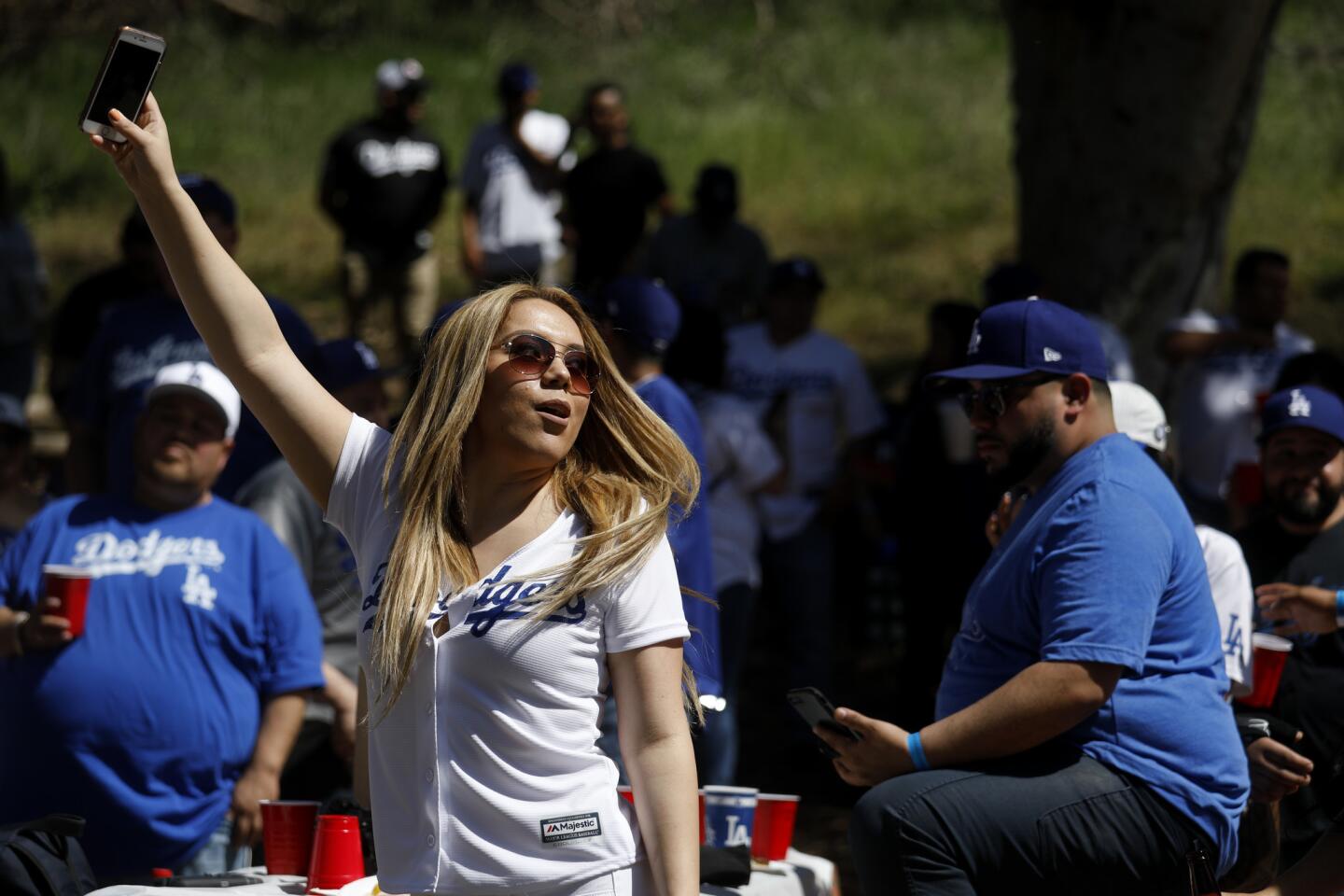 LOS ANGELES, CALIF. -- THURSDAY, MARCH 29, 2018: Melissa Enriquez, of Orange, dances to the music of Banda Tomateros de Culiacan at the Puro Pari 2018 Opening Day tailgate gathering at Elysian Park before the start of the Los Angeles Dodgers against the San Francisco Giants MLB game in Los Angeles, Calif., on March 29, 2018. (Gary Coronado / Los Angeles Times)