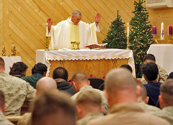 Catholic chaplain Paul Shaughnessy celebrates midnight Mass for Marines at Al Asad, Iraq on Dec. 25. For many of the Marines, it was not their first Christmas away from home.