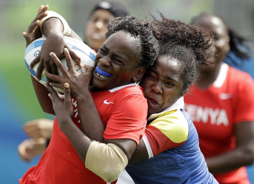 Kenya's Celestine Masinde, left, is tackled by Colombia's Khaterinne Medina, during the women's rugby sevens match at the Summer Olympics in Rio de Janeiro, Brazil, Monday, Aug. 8, 2016. (AP Photo/Themba Hadebe)