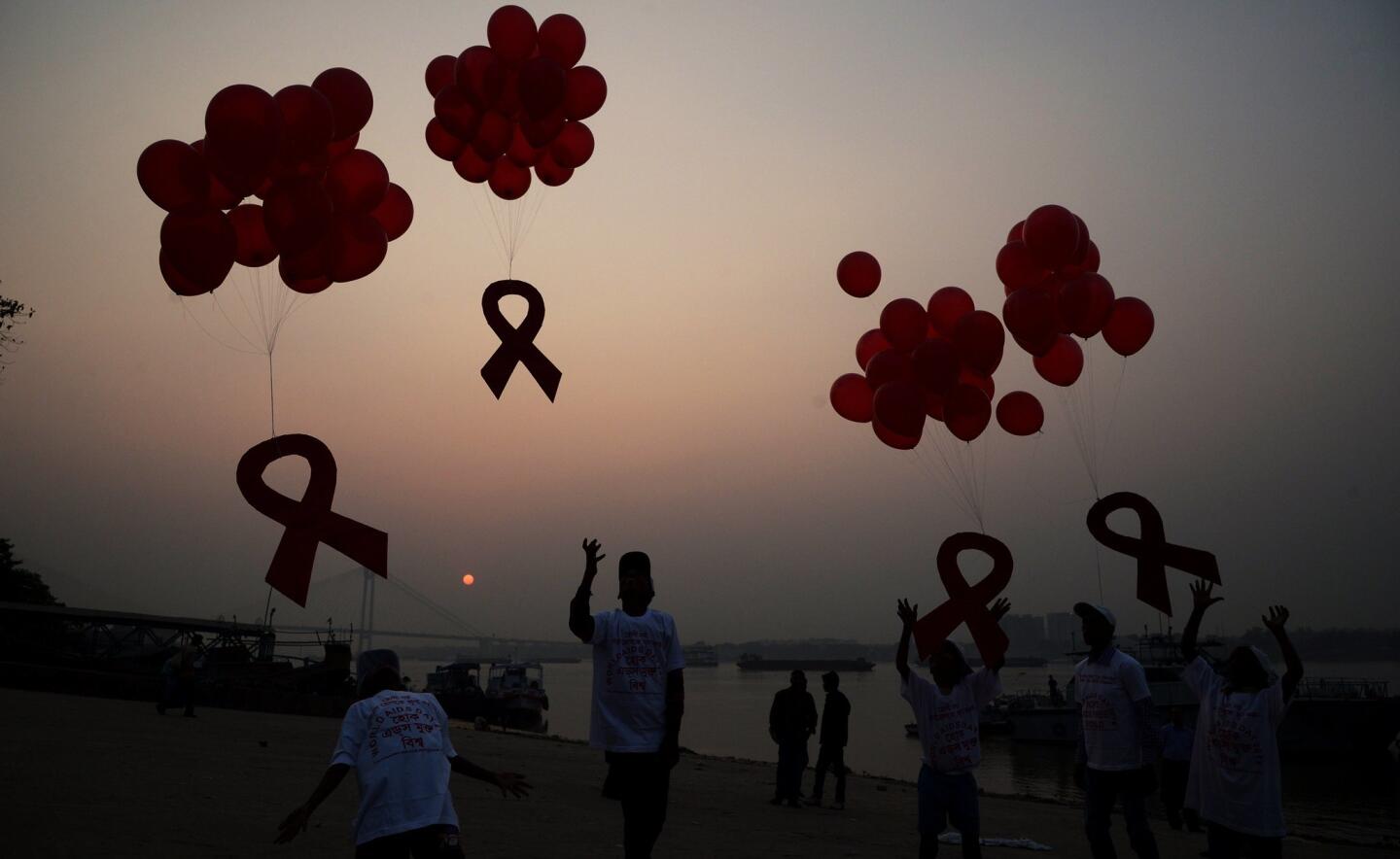 Indian social activists and children release ribbons and balloons during an event to mark World AIDS Day in Kolkata on December 1, 2014. According to the UN AIDS programme, India had the third-largest number of people living with HIV in the world at the end of 2013 and it accounts for more than half of all AIDS-related deaths in the Asia-Pacific region. In 2012, 140,000 people died in India because of AIDS. The Indian government has been providing free antiretroviral drugs for HIV treatment since 2004, but only 50 percent of those eligible for the treatment were getting it in 2012, according to a report by the World Health Organization.