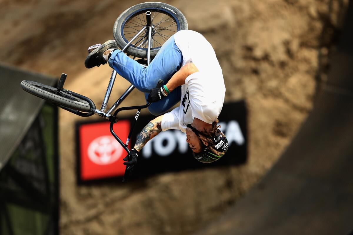 Pat Casey is performing an aerial stunt in a BMX Dirt qualifier at the ESPN X-Games.