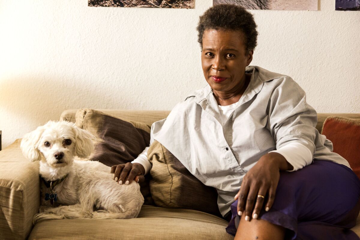 Poet Claudia Rankine, photographed at home with dog Sammy, has won the 2014 National Book Critics Circle Award for poetry.
