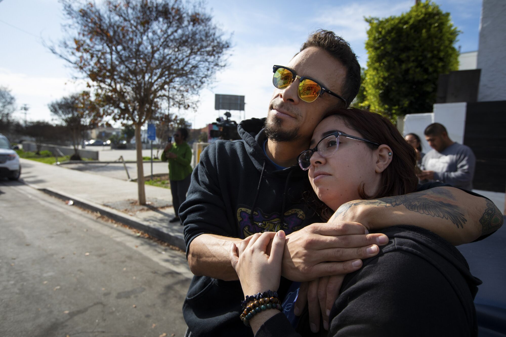 Edwin Lopez and Rose Fliegel take a moment at the site of the mural of Kobe Bryant and his daughter, Gianna, in Los Angeles.