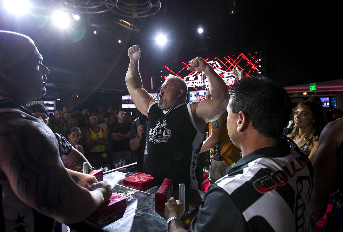 Mike Gould, right, celebrates a win over Matt Girdner in the super heavyweight division during an Ultimate Arm Wrestling League tournament at TEN Nightclub in Newport Beach on Saturday, August 9.