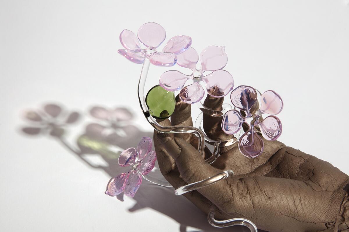 "Cultivator (Hanami)," a bronze cast of the artist's hand with hand-blown glass flowers in "Kelly Akashi: Formations" 