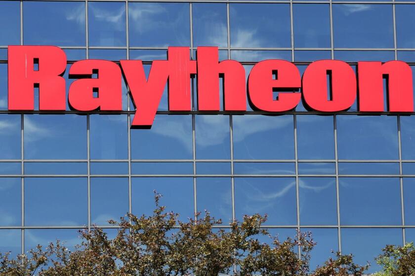 The sky is reflected on the facade of Raytheon's Integrated Defense Systems facility, Monday, June 10, 2019, in Woburn, Mass. Raytheon Co. and United Technologies Corp. are merging in a deal that creates one of the world's largest defense companies. (AP Photo/Elise Amendola)