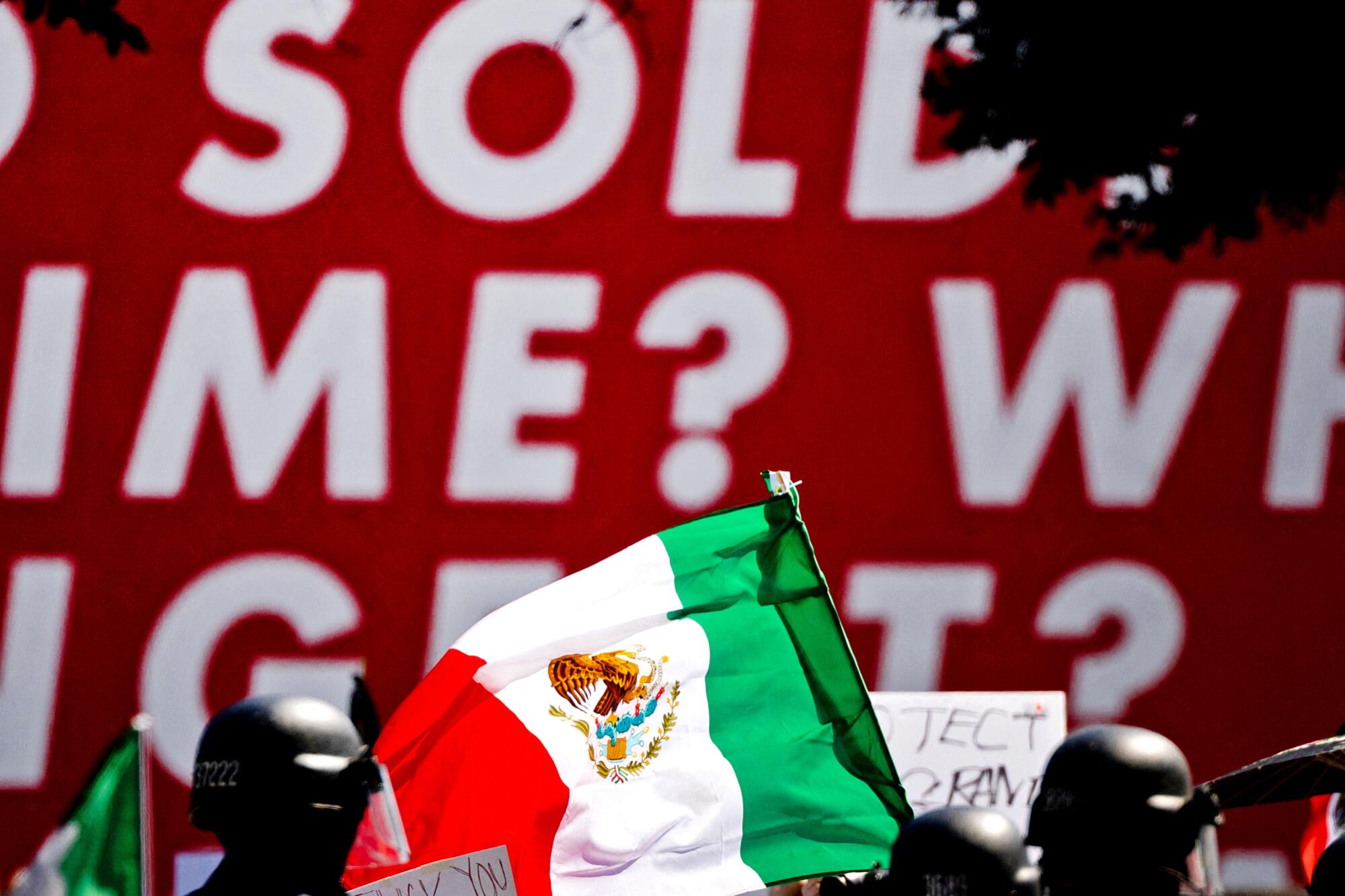 Law enforcement officers and other people, with some holding flags.