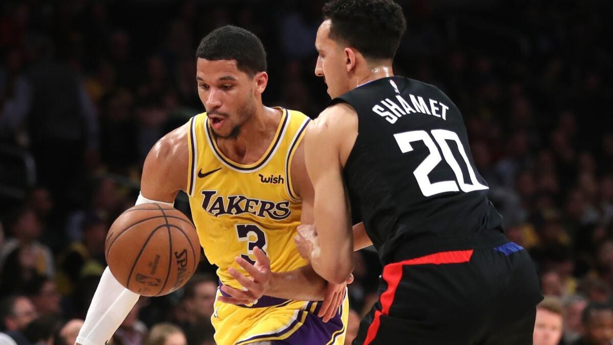 Lakers guard Josh Hart tries to regain control of the ball as he drives past Clippers guard Landry Shamet during the second half Monday.