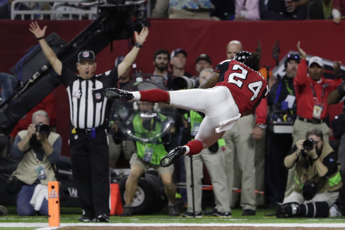 Falcons running back Devonta Freeman dives into the end zone after scoring the opening touchdown of Super Bowl LI. The Falcons released Freeman on Tuesday.