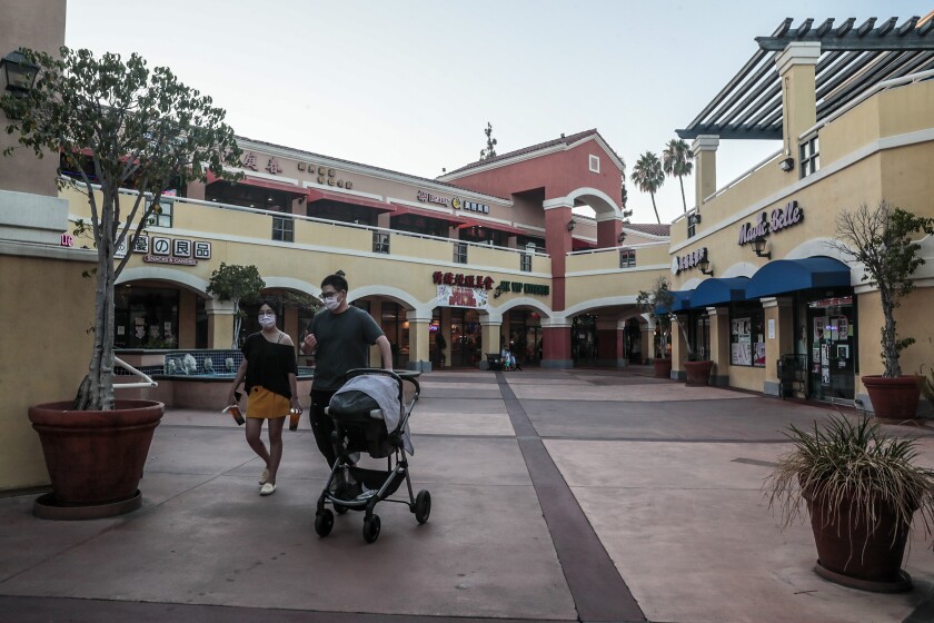  A few visitors linger near the shops and restaurants in San Gabriel Square. 
