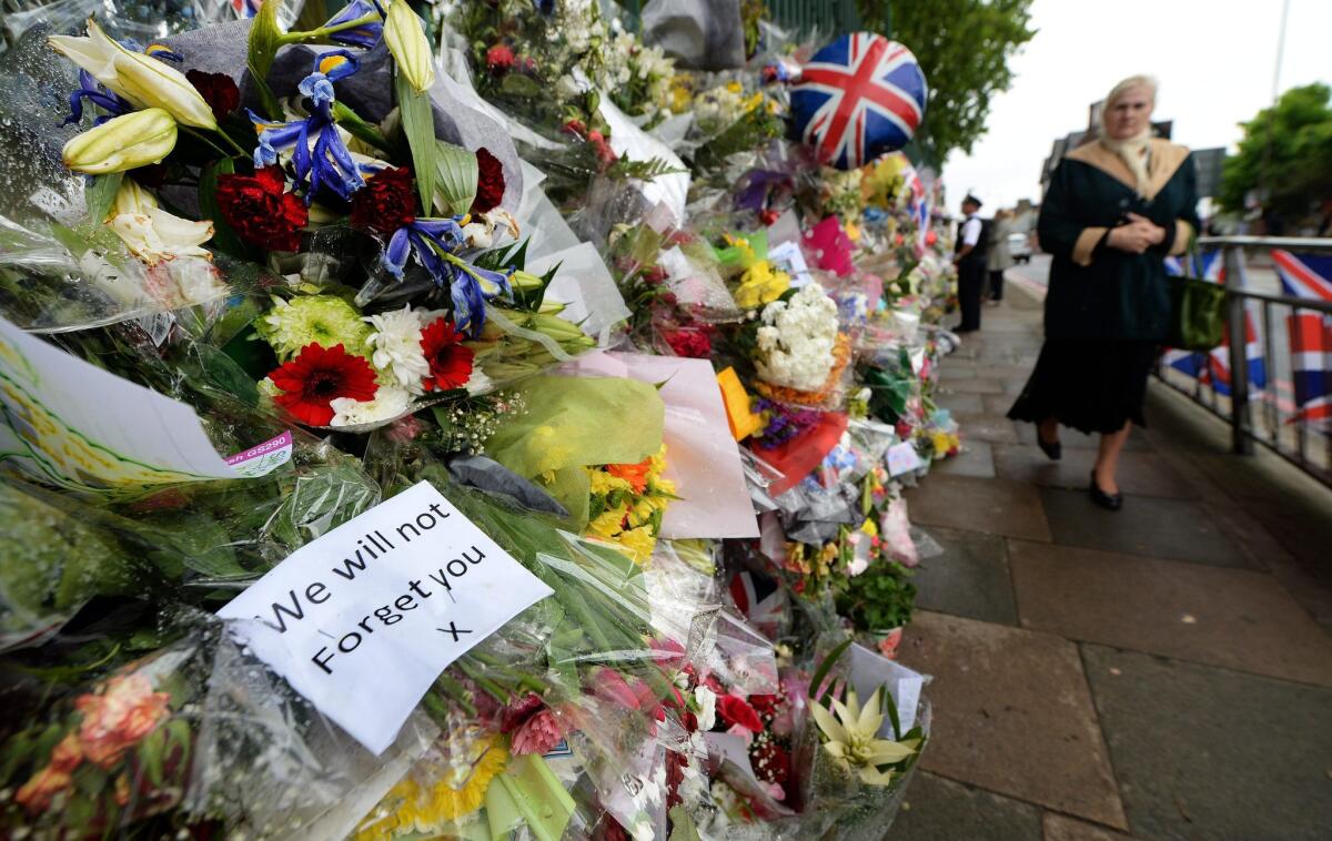 Tributes to slain British soldier Lee Rigby are placed outside the Royal Artillery Barracks at Woolwich in London.