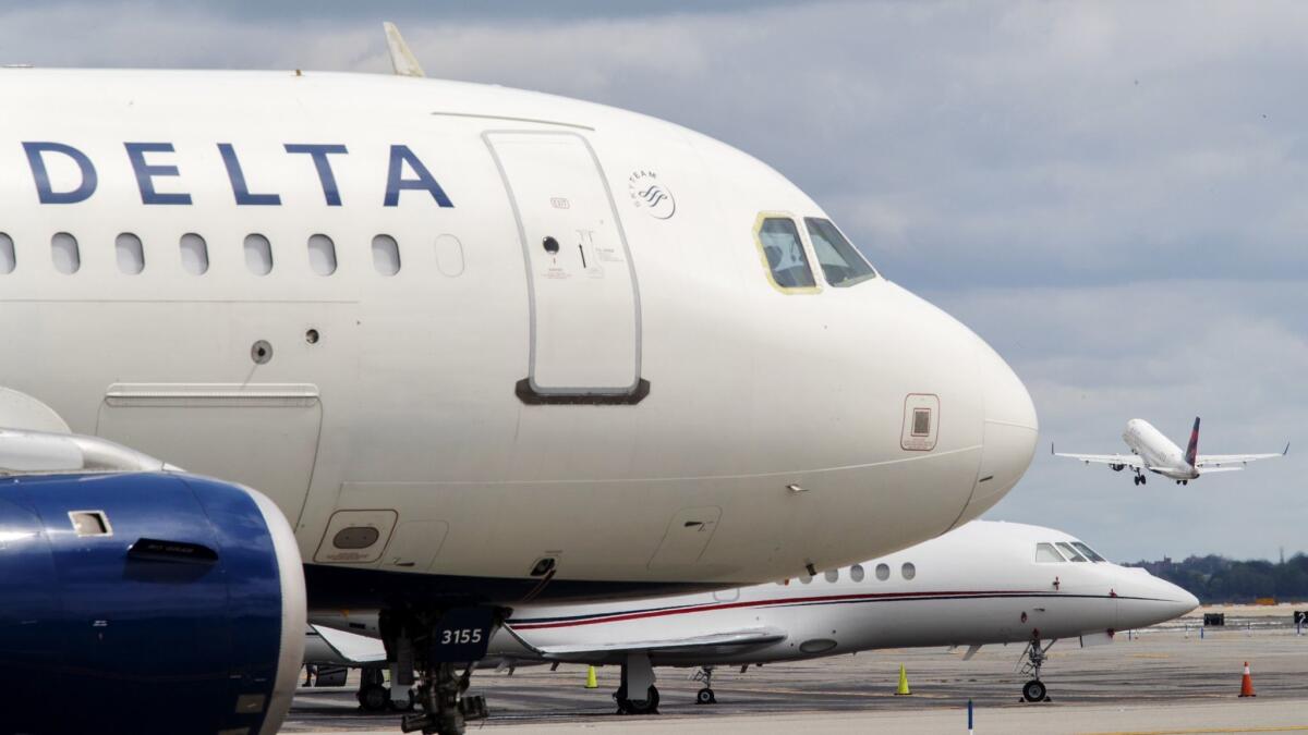 In a file photo, a Delta Air Lines jet waits on the tarmac at LaGuardia Airport in New York.