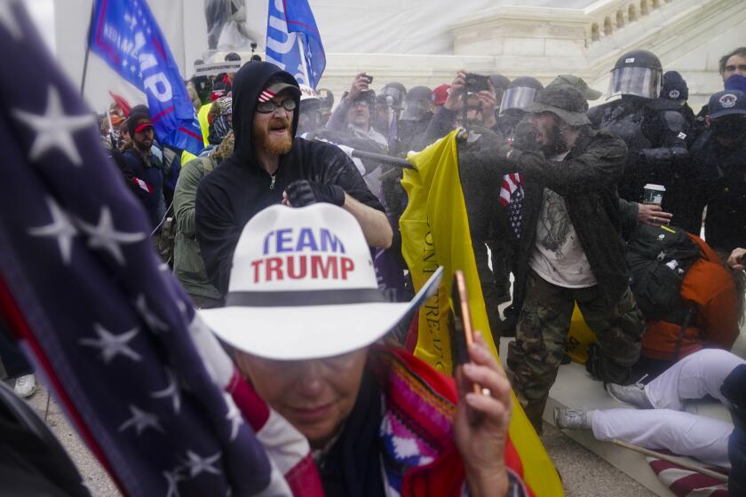 FILE - In this Jan. 6, 2021, file photo, rioters try to break through a police barrier, at the Capitol in Washington. (AP Photo/John Minchillo, File)