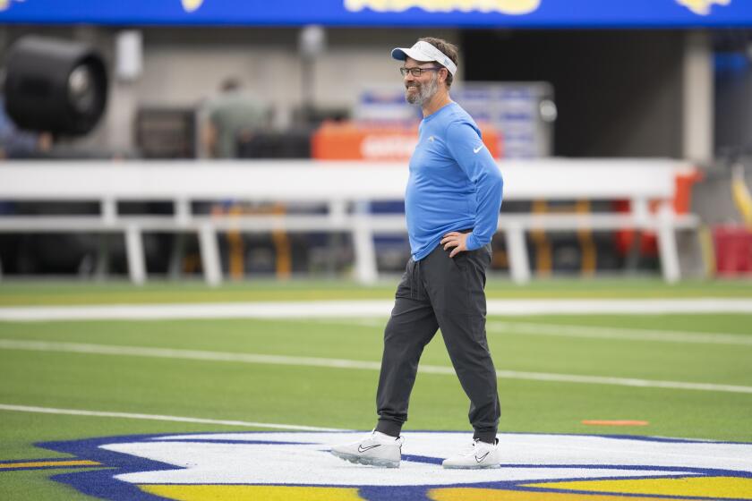Los Angeles Chargers quarterbacks coach Shane Day watches his players before an NFL football game against the Los Angeles Rams Saturday, Aug. 14, 2021, in Inglewood, Calif. (AP Photo/Kyusung Gong)