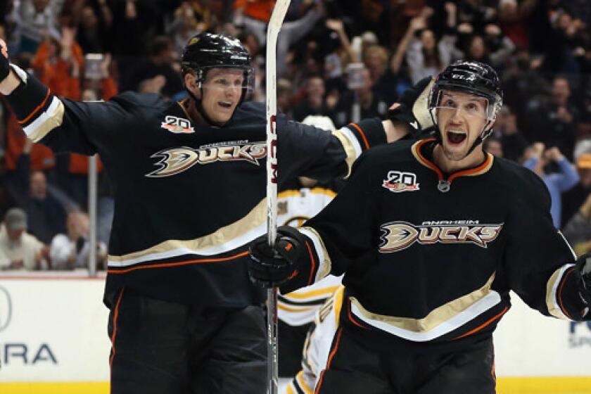 Ducks forward Nick Bonino, right, celebrates with teammate Corey Perry after scoring a third-period goal in a 5-2 win over the Boston Bruins on Tuesday. The high-flying Ducks will look to extend their winning streak to five games with a road win Thursday over the Nashville Predators.