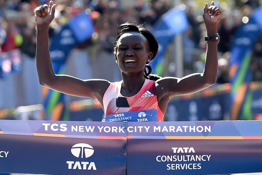 Mary Keitany crosses the finish line Sunday to win her third consecutive New York City Marathon.