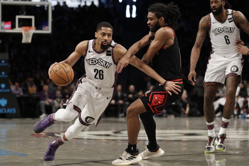 FILE - In this Sunday, March 8, 2020 file photo, Brooklyn Nets' Spencer Dinwiddie (26) drives to the basket around Chicago Bulls' Coby White during the second half of an NBA basketball game at the Barclays Center in New York. Kevin Durant and Kyrie Irving aren’t coming back, DeAndre Jordan and Wilson Chandler aren’t going to Florida, and Spencer Dinwiddie’s status is unclear after he and Jordan tested positive for the coronavirus. The Brooklyn Nets don’t have much of a team left, but general manager Sean Marks says they never considered not restarting the season later this month. (AP Photo/Seth Wenig, File)