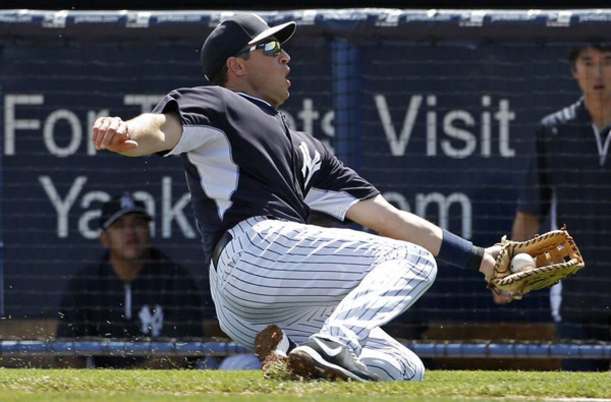 Yankees first baseman Mark Teixeira makes a sliding catch of a pop-up by Braves second baseman Dan Uggla during an exhibition game last month.